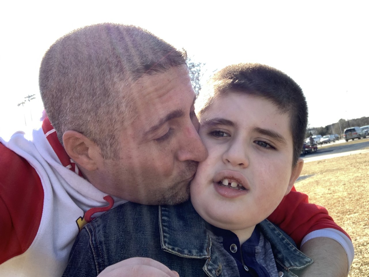 Father kissing his son on the cheek