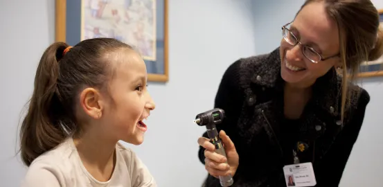 A doctor and young patient at the Thompson Center for Autism and Neurodevelopmental Disorders