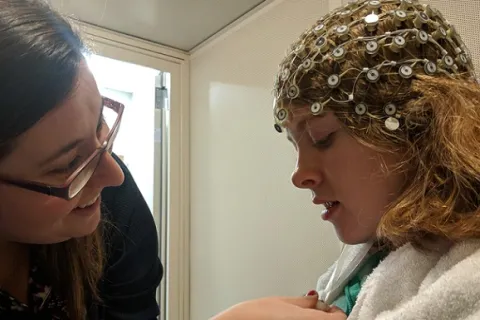 a young girl getting ready for a brain scan