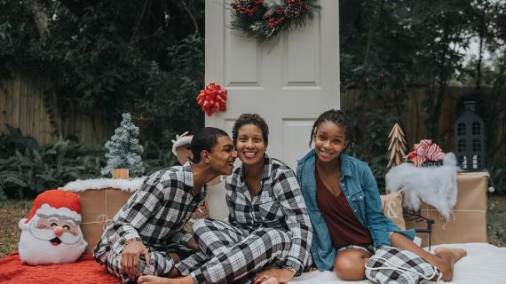 Blogger Michelle with her daughter and son posing in pajamas for a holiday card