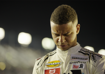 Autistic NASCAR driver Armani Williams with his head down and eyes closed