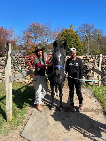 Jasmyn and her mom next to a horse