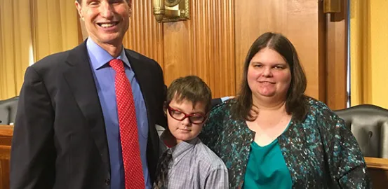 2 adults and 1 child in a courtroom