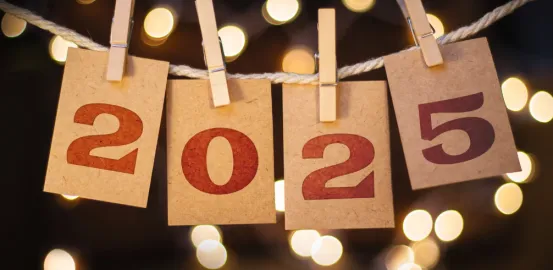 a banner with the year 2025 displayed on a rope with clothespins holding up each number in the year