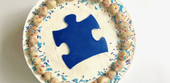 Cake with an autism symbol puzzle piece on it