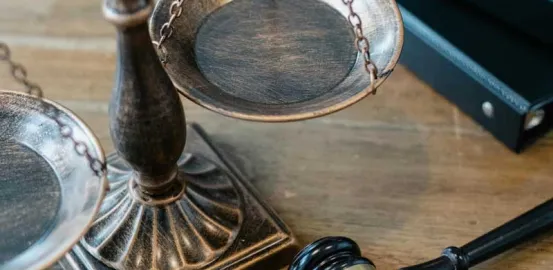 Justice Scales and Gavel on Wooden Surface
