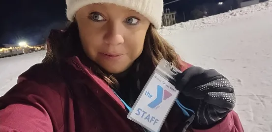 Kayla C. holding her YMCA staff badge