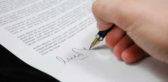 Person Signing in Documentation Paper