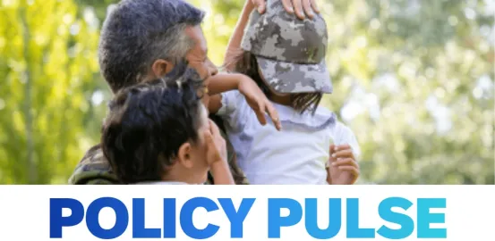 man with arms around two children wearing army camo