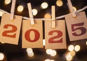 a banner with the year 2025 displayed on a rope with clothespins holding up each number in the year
