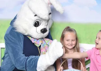 two children with the Easter bunny at a sensory-friendly Bunny Cares event hosted by Autism Speaks and Cherry Hill Programs