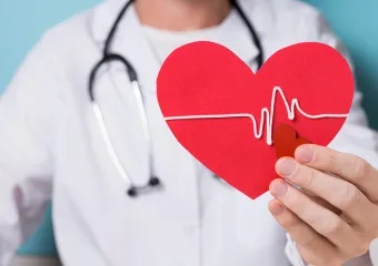 Doctor holding a paper heart