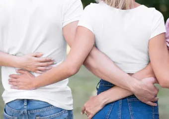 group of friends with their arms around each others backs