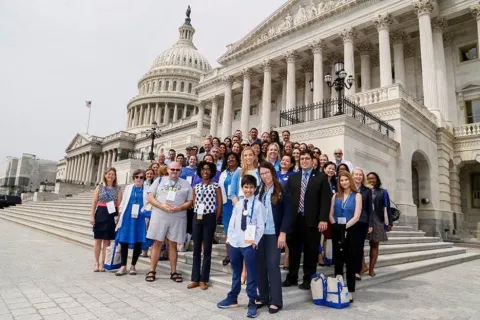 Group of advocates standing on the Capitol steps