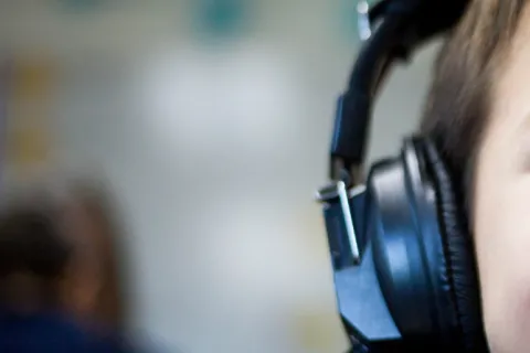 Child wearing headphones to help with auditory processing disorder