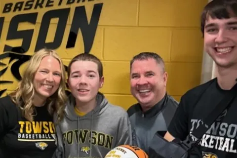 Coach Skerry and his family in the basketball locker room
