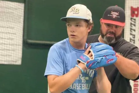 Dougie Bedinger taking pitching practice with dad Doug