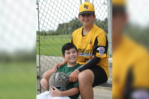 Dylan James Strode and his brother in their baseball uniforms