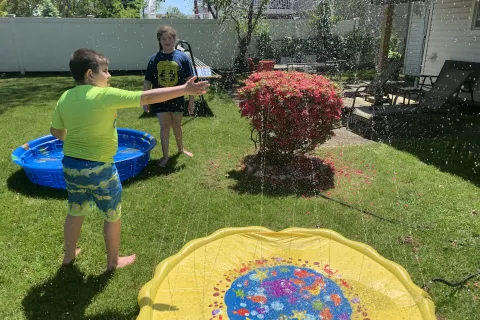 James Guttman with his kids on the trampoline