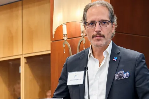 Jose Gregorish speaking at a podium
