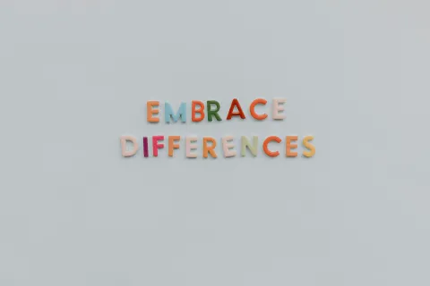 Letter magnets on a refrigerator that spell out Embrace Differences