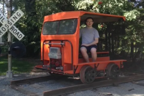 Patrick Vaillancourt sitting in an orange train