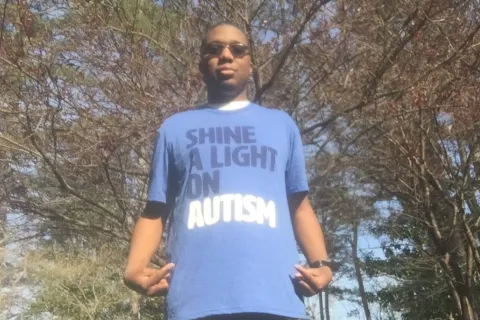Ryan Lee wearing an Autism Speaks shirt