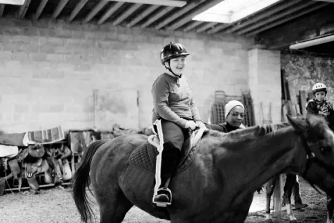 child riding a horse as a form of equine therapy for autism