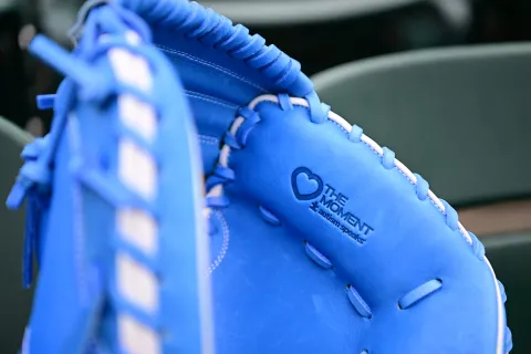 close up of a blue baseball glove made by Wilson to support Autism Speaks