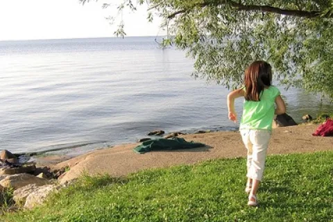 child running by a lake