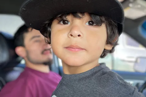 Little boy wearing a baseball hat