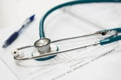 Stethoscope and pen on a medical chart