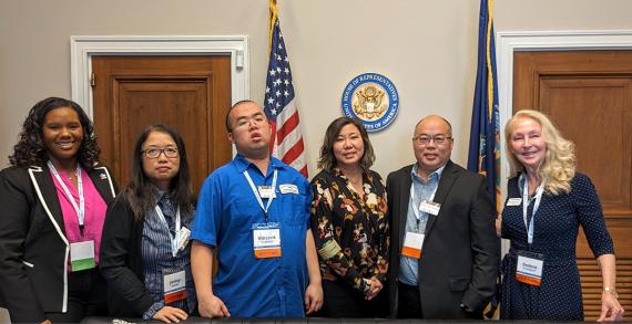 Five advocates (including the Feng family) standing in a line with Congresswoman Grace Meng