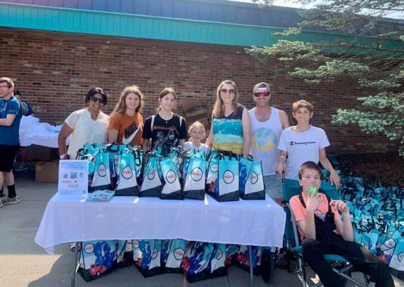a group of people handing out care packages
