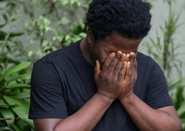 Man with face in hands dealing with anxiety