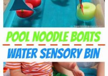 child playing with DIY pool noodle boats water sensory bin
