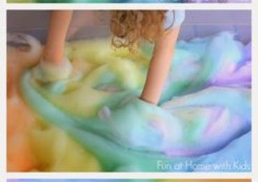 Childs arms playing with DIY sensory rainbow soap foam