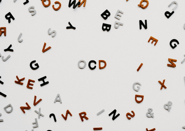 letter scattered around a table with OCD in the center for Obsessive-compulsive disorder (OCD)