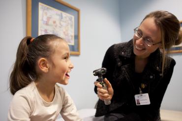 A doctor and young patient at the Thompson Center for Autism and Neurodevelopmental Disorders