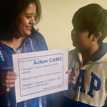 Tulika Prasad and son Vedant holding a sing saying why they care about Autism CARES
