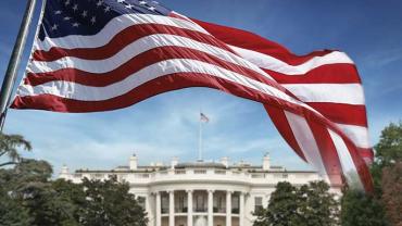 American flag in front of the White House
