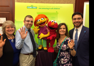 Autism Speaks staff with Julia from Sesame Street