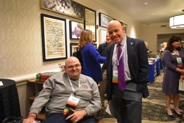 Mike D sitting in scooter next to standing Stuart S