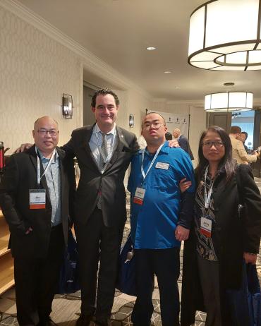 Feng family standing in a line with President & CEO Keith Wargo