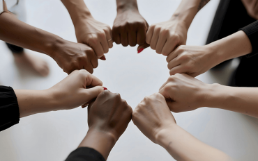 Fists joined in group support meeting