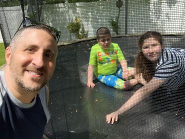 James Guttman with his kids on the trampoline