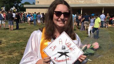Jeanine Castagna wearing sunglasses in a graduation cap and gown