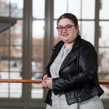 Maddy wearing glasses and a leather jacket