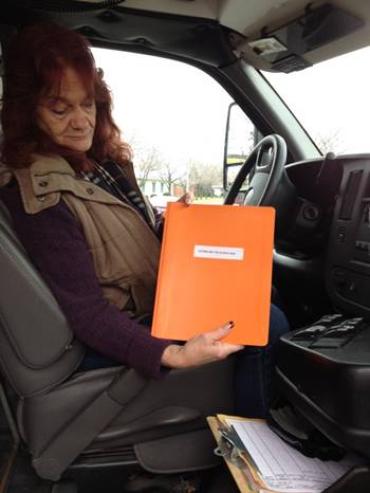 Mary Lawson holding her workbook after attending the ASD Bus Driver workshop