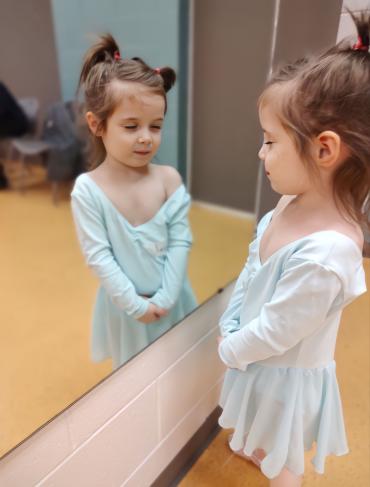 Ayah looking in the mirror at dance class